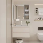 A modern bathroom featuring a vanity with a lighted mirror, white sink, and organized wall shelves with decor and toiletries.