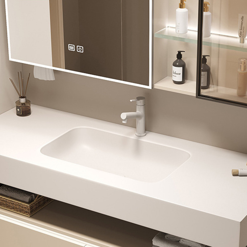 Modern bathroom vanity with white sink, sleek faucet, and an illuminated mirror cabinet with toiletries on shelves.