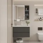 Stylish bathroom featuring a dark vanity with a white countertop, illuminated mirror cabinet, and wall shelves adorned with toiletries.