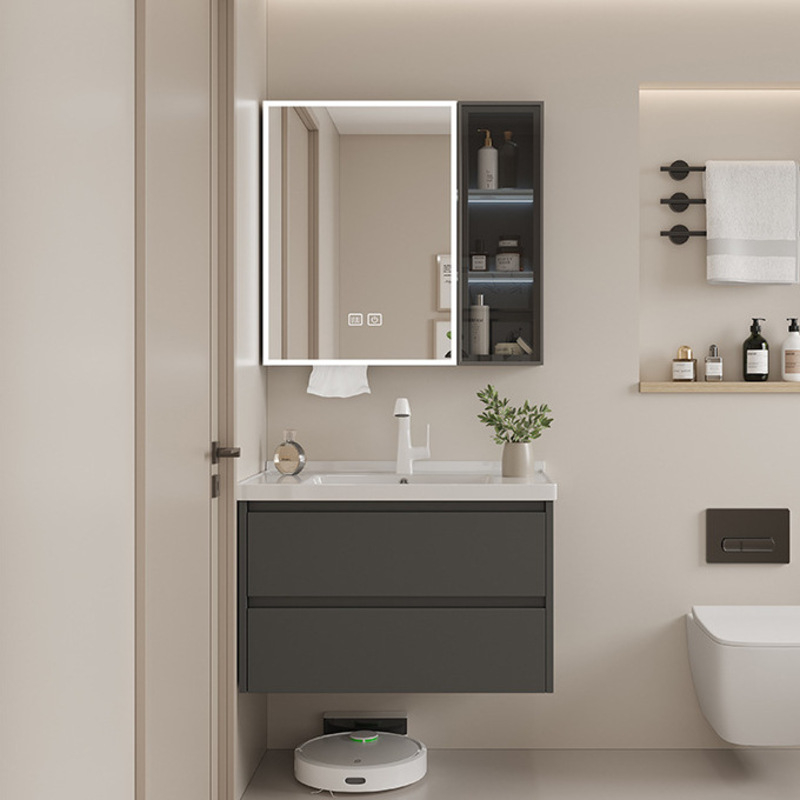 Stylish bathroom featuring a dark vanity with a white countertop, illuminated mirror cabinet, and wall shelves adorned with toiletries.