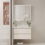 Modern bathroom vanity featuring a sleek illuminated mirror, beige drawers, and a small potted plant on a white countertop.