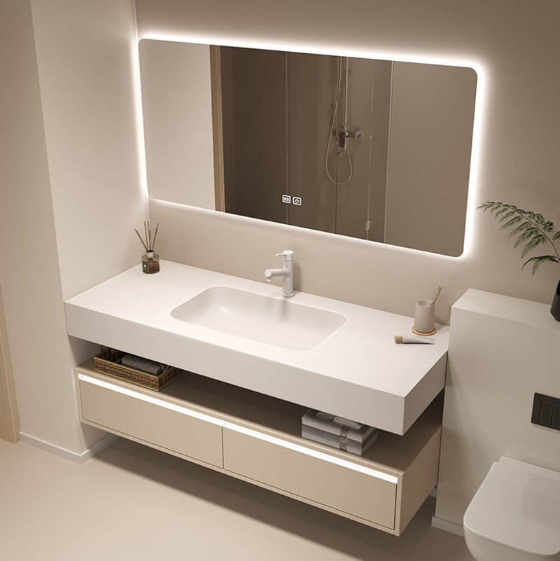 Contemporary bathroom vanity featuring a sleek white countertop with integrated sink, an illuminated rectangular mirror, storage shelves, and minimalist decor.