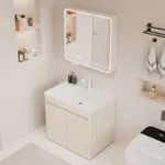 Stylish bathroom setup featuring a modern vanity with a white basin, illuminated mirror cabinet, and shelving with toiletries.