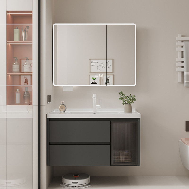 Contemporary bathroom scene featuring a sleek, dark vanity with drawers, illuminated mirror cabinet, and minimalist decor.