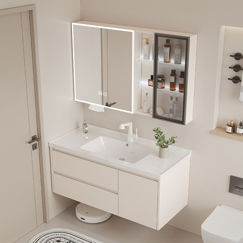 Minimalist bathroom featuring a modern vanity with sink, illuminated mirror cabinet, and shelving with toiletries.