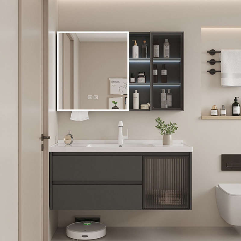 Modern bathroom featuring a sleek vanity with storage alongside a mirrored cabinet and shelves adorned with toiletries and decor.