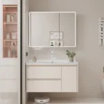 Contemporary bathroom featuring a sleek vanity with drawers, illuminated mirror, and minimalist decor.